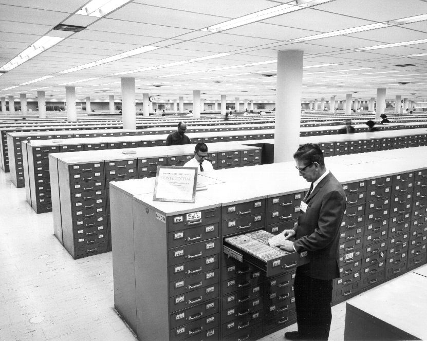 man at filing cabinets