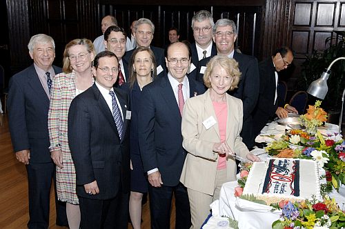 group of Social Security officials cutting ceremonial cake