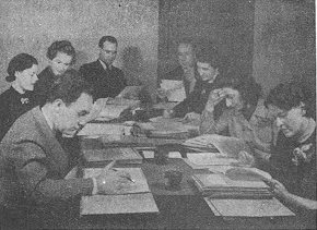 group around table working on papers