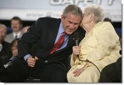 President George W. Bush leans in for a whisper from Cecil Ferrell, founder and owner of Ferrell’s Hamburgers in Hopkinsville, Ky., one of the participants in the President's Conversation on Strengthening Social Security Thursday, June 2, 2005, at the Hopkinsville Christian County Conference and Convention Center.  White House photo by Eric Draper