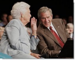 President George W. Bush talks to his mother Barbara Bush, Friday, July 22, 2005, during their appearance at a Conversation on Senior Security at the Boisfeuillet Jones Civic Center in Atlanta, to talk about Social Security and Medicare.  White House photo by Paul Morse