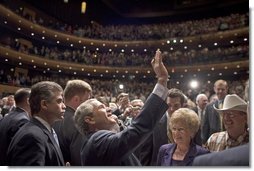 President George W. Bush waves to people in the balconies after participating in a conversation on strengthening Social Security at the Cannon Center for the Performing Arts in Memphis, Tenn., Friday, March 11, 2005. White House photo by Paul Morse 