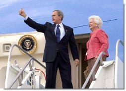 Before departing Pensacola en route Orlando, Fla., President George W. Bush gives a thumbs up sign while boarding Air Force One with his mother Barbara Bush Friday, March 18, 2005. White House photo by Eric Draper 