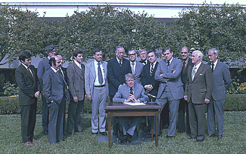 larger photo of Carter signing bill in Rose Garden