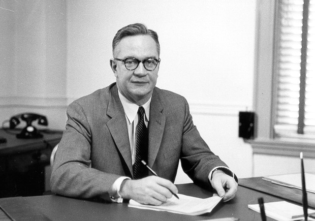 Ball at desk signing paper