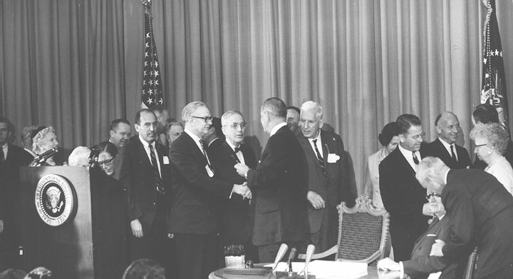 LBJ shaking hands with Ball and talking to Altmeyer