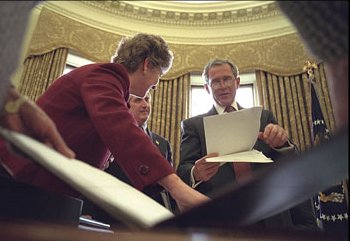 President Bush with staff reading speech