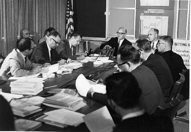 men seated around large table