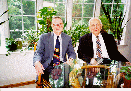 color photo of Myers and DeWitt at glass top table