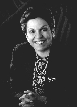 bw photo of Shalala smiling with hands folded