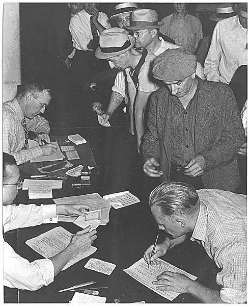 photo of men signing forms for unemployment benefits