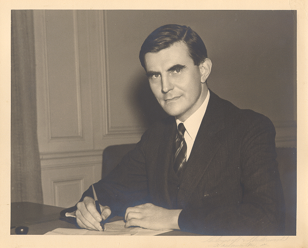photo of John Winant at desk