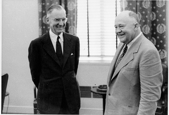 bw photo of two men in suits standing