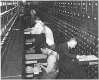 photo of researchers looking through card files