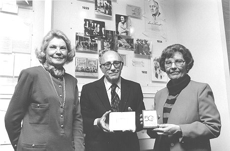 two women and a man with plaque