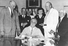 Photograph of President Roosevelt signing the Social Security Act, August 1935